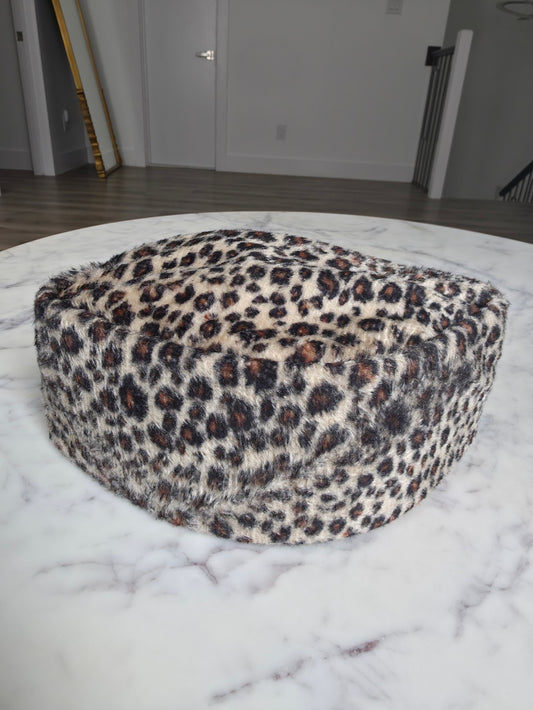 Afrocentric Kufi cap featuring a bold leopard animal print on a textured velvet fabric with a foldable, structured silhouette.