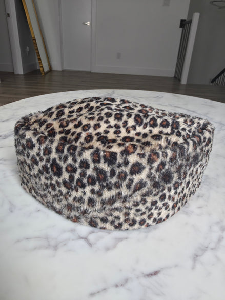 Afrocentric Kufi cap featuring a bold leopard animal print on a textured velvet fabric with a foldable, structured silhouette.