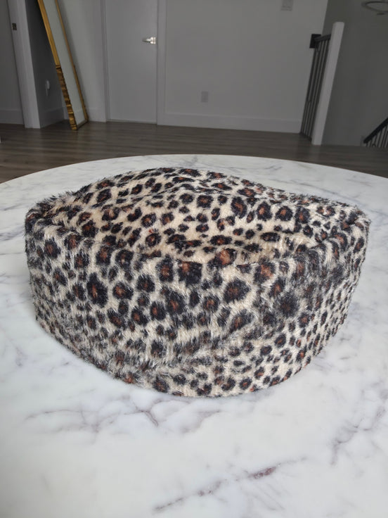 Afrocentric Kufi cap featuring a bold leopard animal print on a textured velvet fabric with a foldable, structured silhouette.