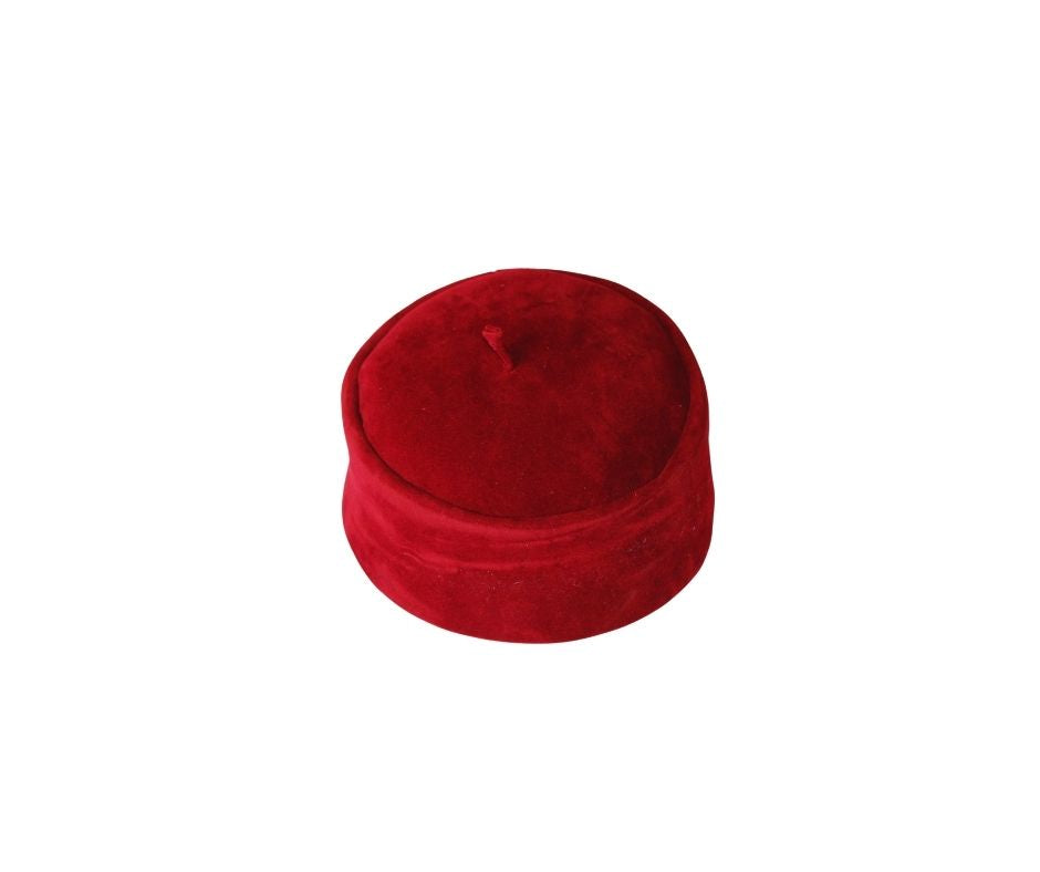 Kufi Hat featuring a circular crimson red velvet crown with a structured side band and a small top tassel.