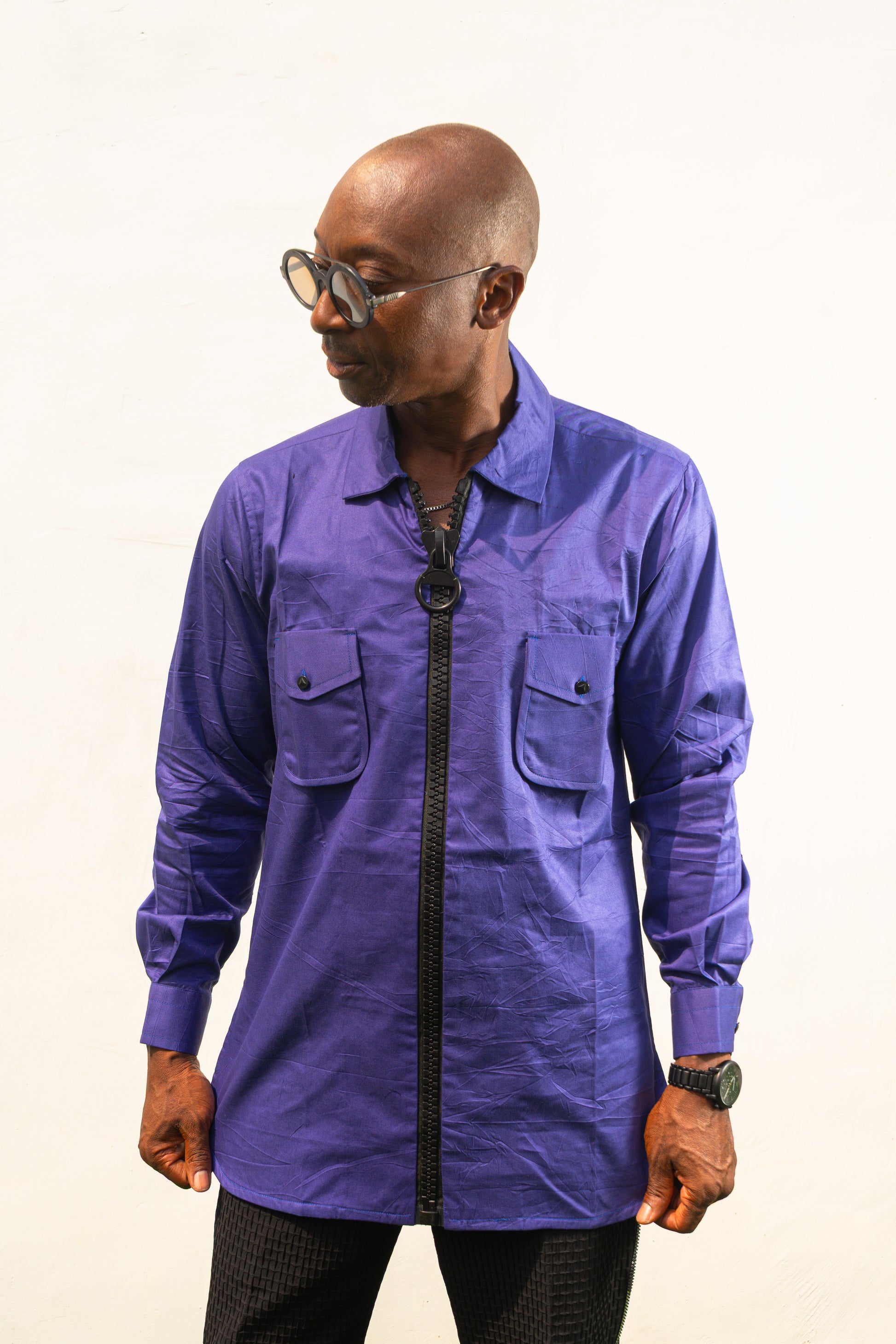 Long Sleeve Shirt featuring a vibrant royal blue cotton tunic with a prominent black central zipper, two chest pockets, and a classic collar. Front.