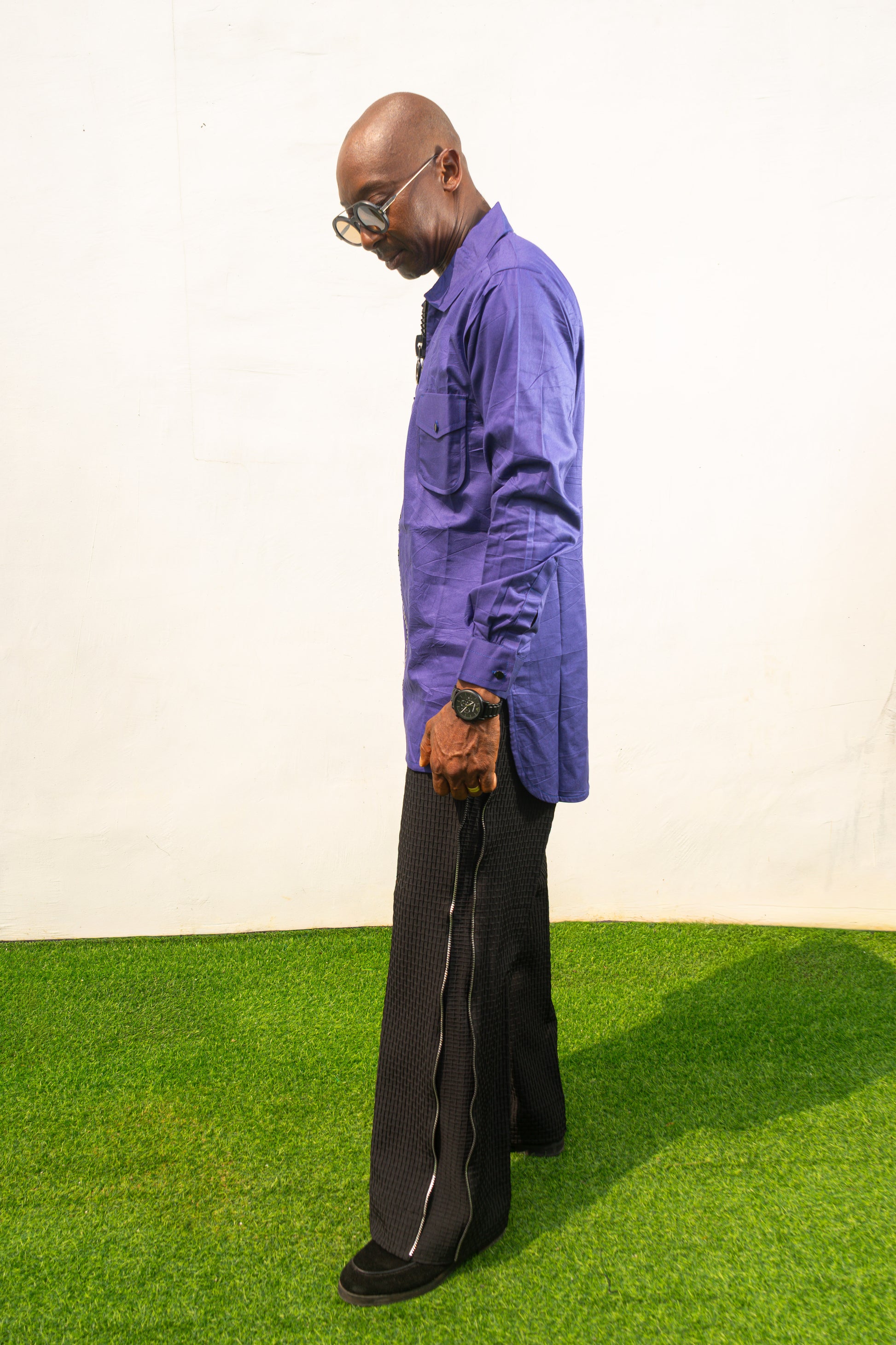 Long Sleeve Shirt featuring a vibrant royal blue cotton tunic with a prominent black central zipper, two chest pockets, and a classic collar. Side View.