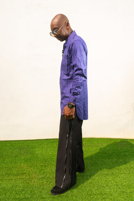 Long Sleeve Shirt featuring a vibrant royal blue cotton tunic with a prominent black central zipper, two chest pockets, and a classic collar. Side View.