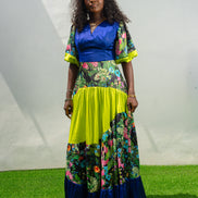 Maxi Dress featuring a solid blue V-neck bodice, floral print sleeves and skirt, and vibrant lime green tiered accents.