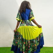 Maxi Dress featuring a solid blue V-neck bodice, floral print sleeves and skirt, and vibrant lime green tiered accents. Back View