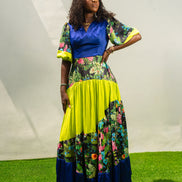 Maxi Dress featuring a solid blue V-neck bodice, floral print sleeves and skirt, and vibrant lime green tiered accents.