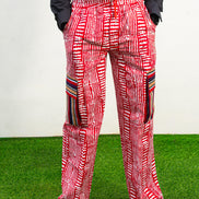 Men's cargo pants featuring a red and white Ankara print, a straight-leg silhouette, and multi-colored striped pocket details.