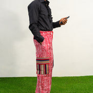 Men's cargo pants featuring a red and white Ankara print, a straight-leg silhouette, and multi-colored striped pocket details.