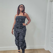Modern Jumpsuit featuring a strapless, smocked tube bodice and relaxed harem-style pants with side pockets and cinched ankle cuffs, showcased in striking geometric African prints.