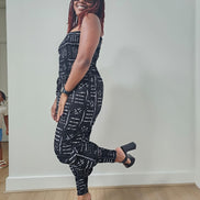 Modern Jumpsuit featuring a strapless, smocked tube bodice and relaxed harem-style pants with side pockets and cinched ankle cuffs, showcased in striking geometric African prints.