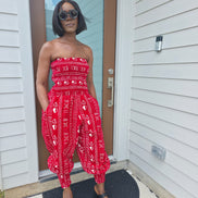Modern Jumpsuit featuring a strapless, smocked tube bodice and relaxed harem-style pants with side pockets and cinched ankle cuffs, showcased in striking geometric African prints.