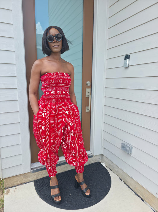 Modern Jumpsuit featuring a strapless, smocked tube bodice and relaxed harem-style pants with side pockets and cinched ankle cuffs, showcased in striking geometric African prints.