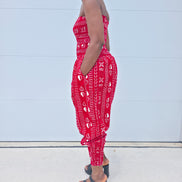 Modern Jumpsuit featuring a strapless, smocked tube bodice and relaxed harem-style pants with side pockets and cinched ankle cuffs, showcased in striking geometric African prints.