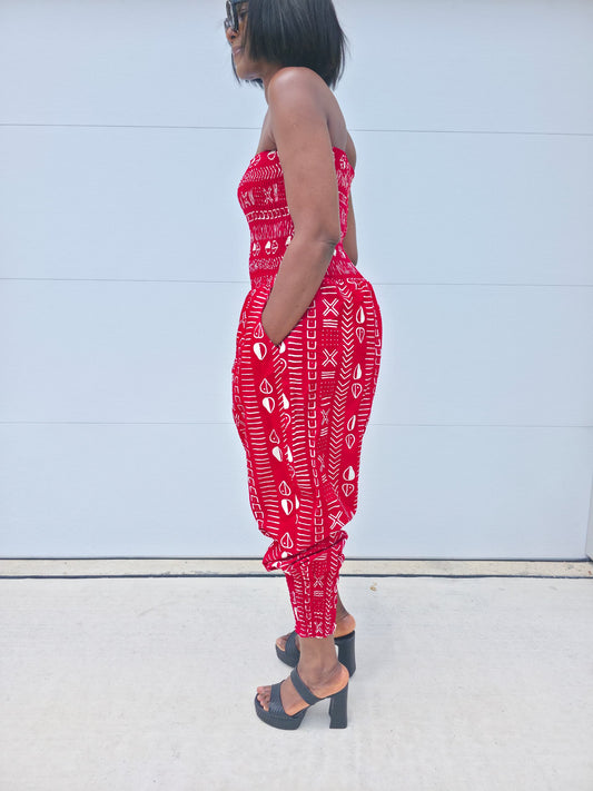 Modern Jumpsuit featuring a strapless, smocked tube bodice and relaxed harem-style pants with side pockets and cinched ankle cuffs, showcased in striking geometric African prints.