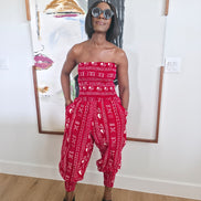 Modern Jumpsuit featuring a strapless, smocked tube bodice and relaxed harem-style pants with side pockets and cinched ankle cuffs, showcased in striking geometric African prints.