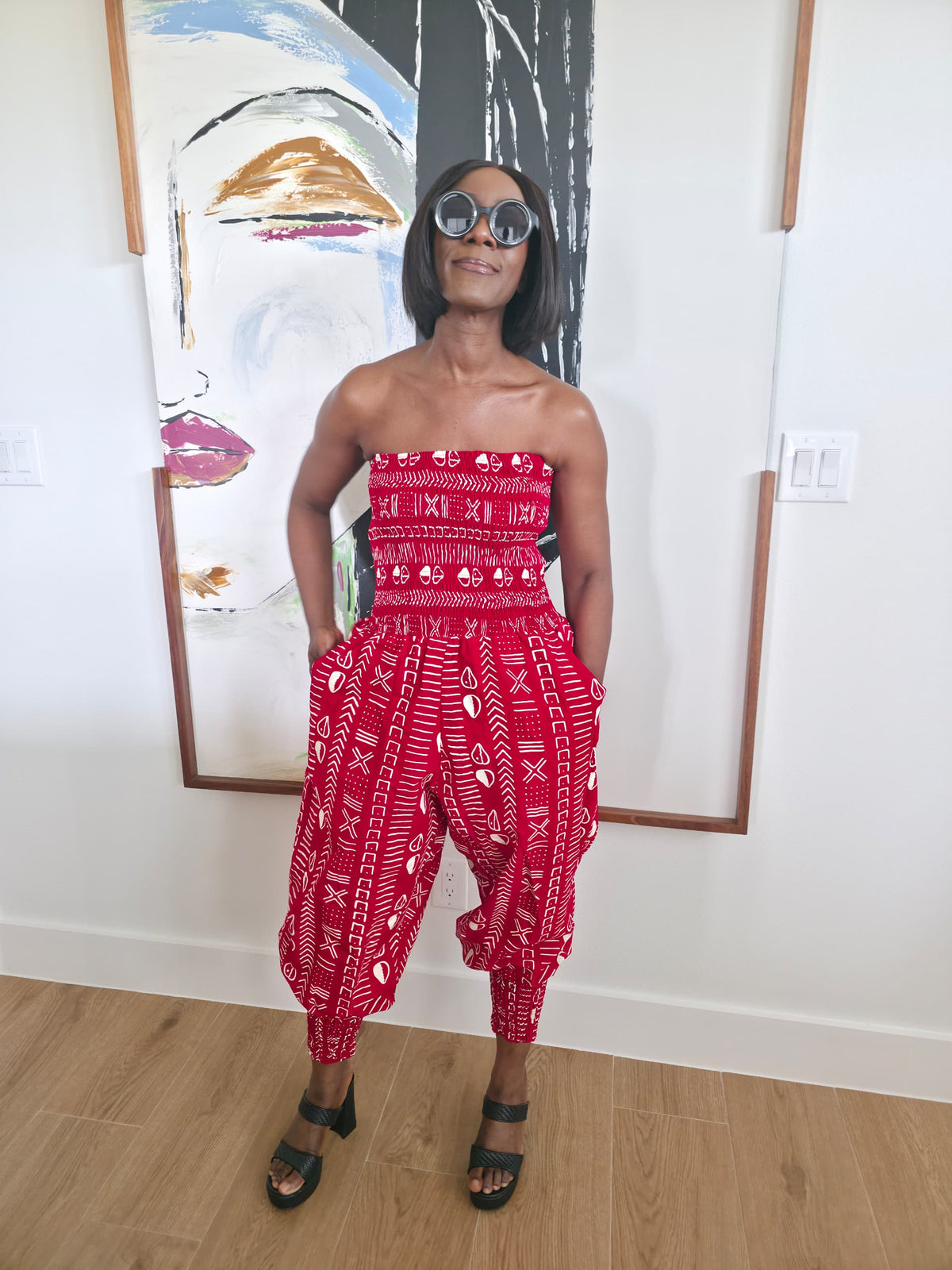 Modern Jumpsuit featuring a strapless, smocked tube bodice and relaxed harem-style pants with side pockets and cinched ankle cuffs, showcased in striking geometric African prints.