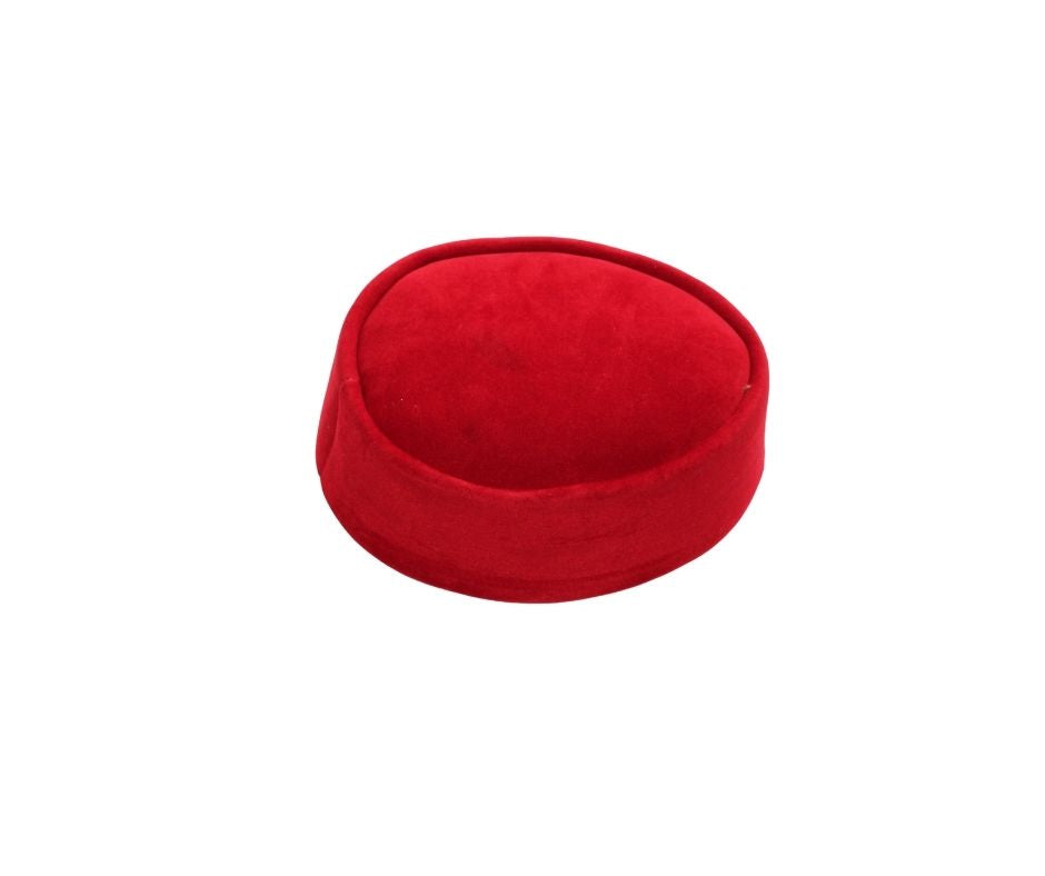 Nze Cap featuring a vibrant ruby red velvet texture, a structured oval top, and a matching fabric-wrapped brim.