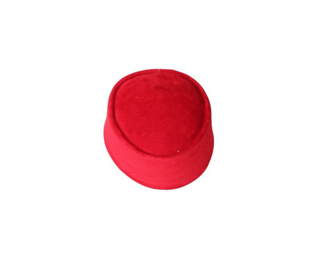 Nze Cap featuring a vibrant ruby red velvet texture, a structured oval top, and a matching fabric-wrapped brim.