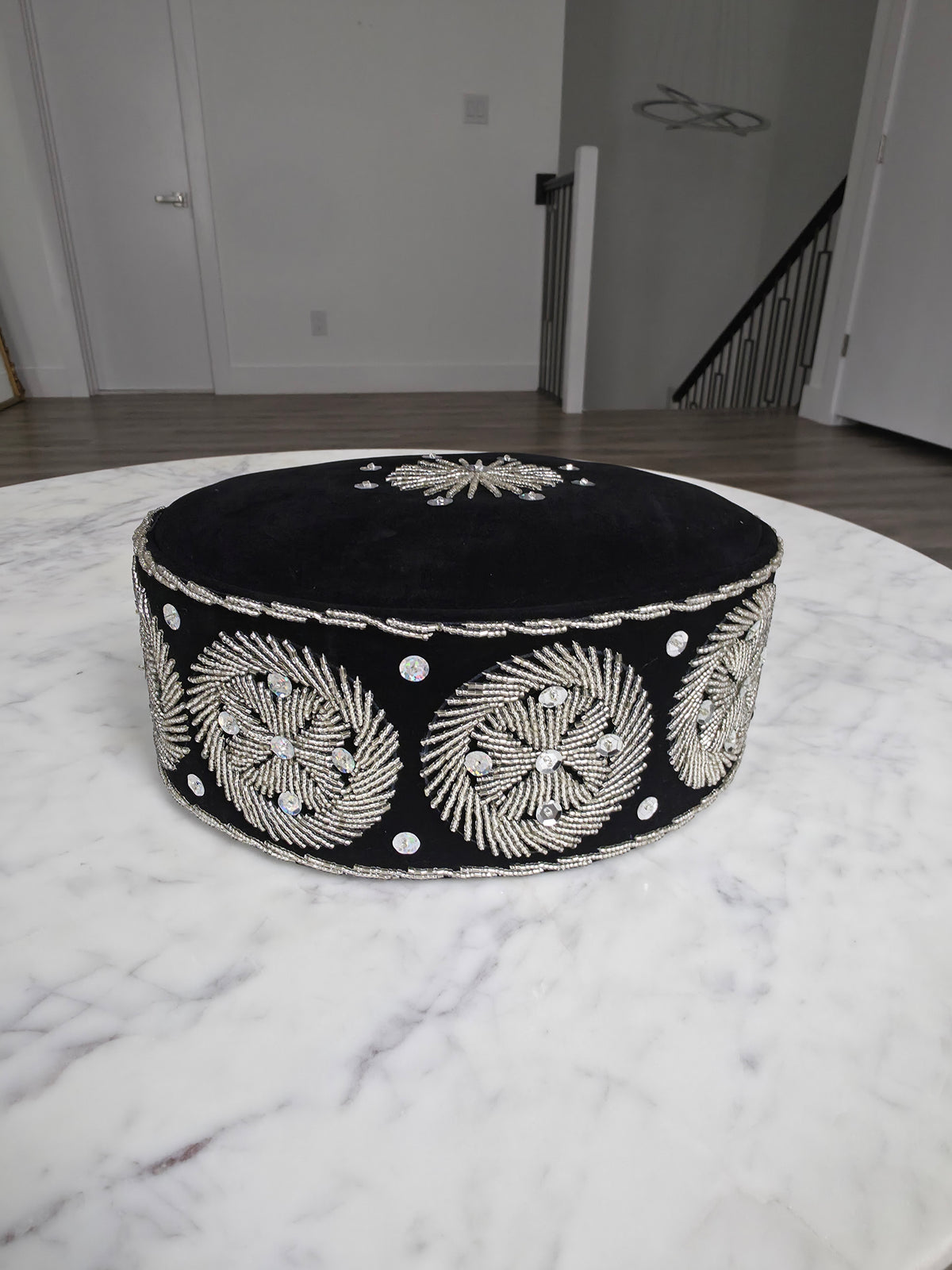 Beaded Ozo Cap featuring black velvet, circular silver beadwork embroidery, and shimmering stone accents.