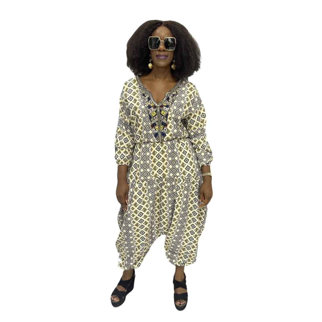Palazzo Jumpsuit featuring a cream and black geometric diamond print, an embellished V-neckline, and a voluminous drop-crotch silhouette.