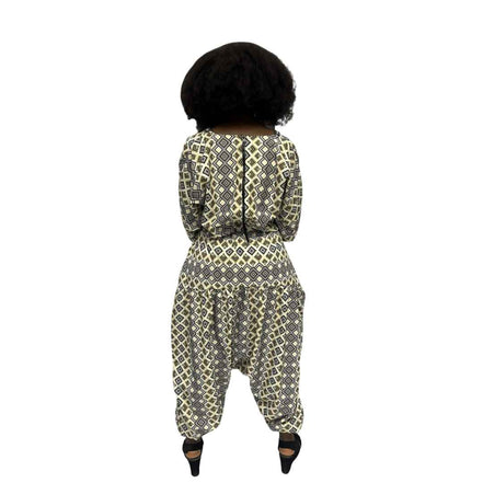 Palazzo Jumpsuit featuring a cream and black geometric diamond print, an embellished V-neckline, and a voluminous drop-crotch silhouette.