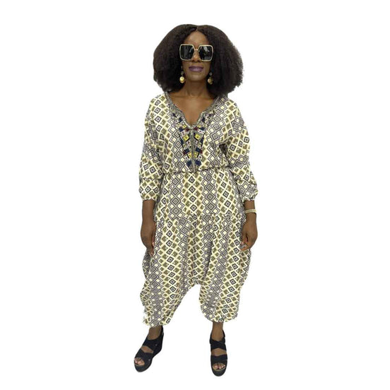 Palazzo Jumpsuit featuring a cream and black geometric diamond print, an embellished V-neckline, and a voluminous drop-crotch silhouette.