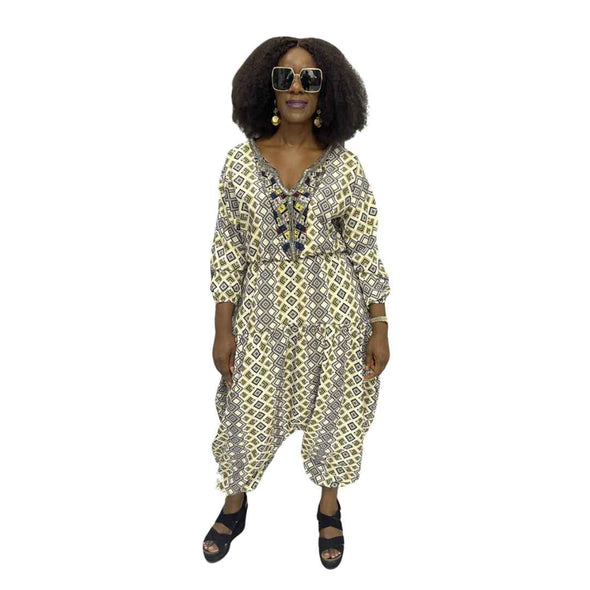 Palazzo Jumpsuit featuring a cream and black geometric diamond print, an embellished V-neckline, and a voluminous drop-crotch silhouette.