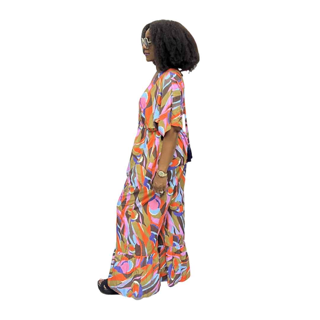 Palazzo Jumpsuit featuring a colorful abstract wave print, V-neckline, and wide legs with tiered ruffled hems.