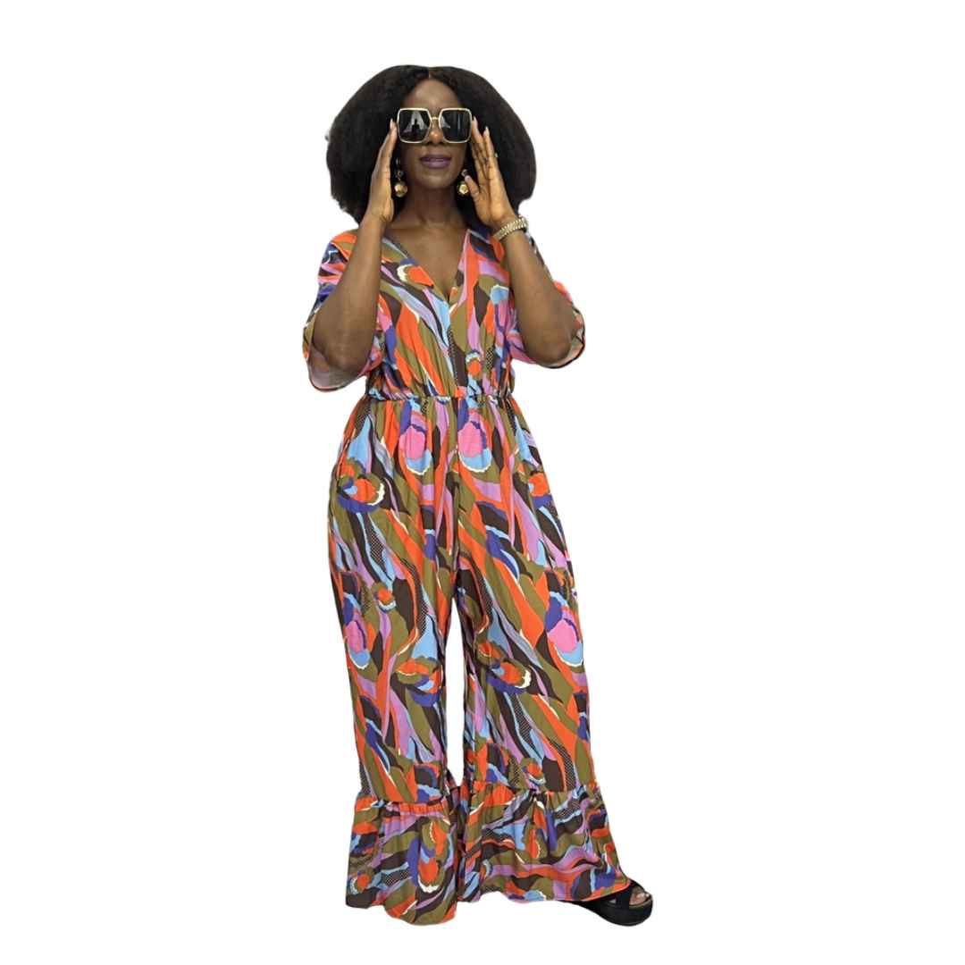 Palazzo Jumpsuit featuring a colorful abstract wave print, V-neckline, and wide legs with tiered ruffled hems.