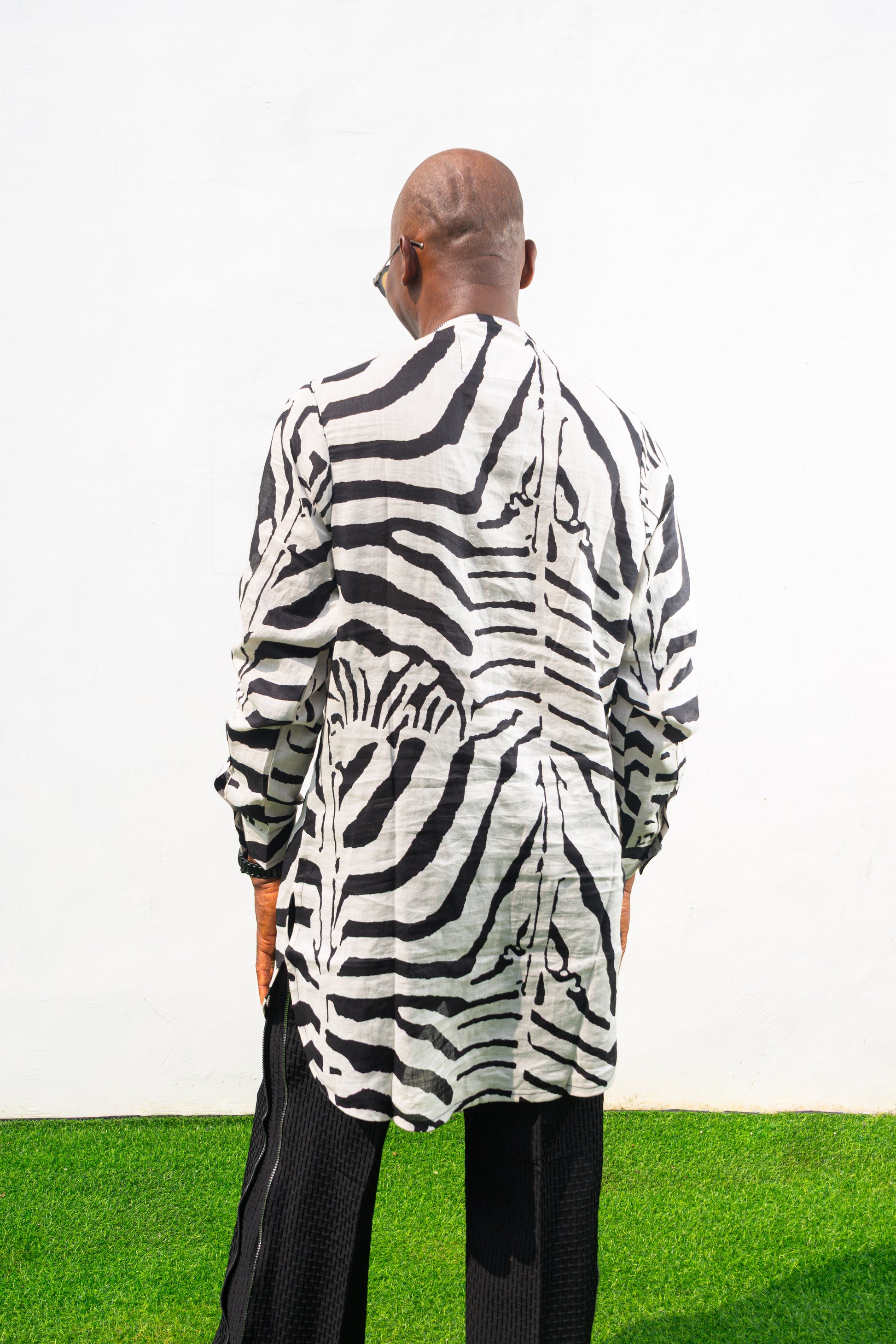 Patterned Shirt featuring a long-sleeve white tunic with bold black zebra-inspired patterns, a buttoned neckline, and a straight hem. Back View