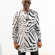 Patterned Shirt featuring a long-sleeve white tunic with bold black zebra-inspired patterns, a buttoned neckline, and a straight hem.