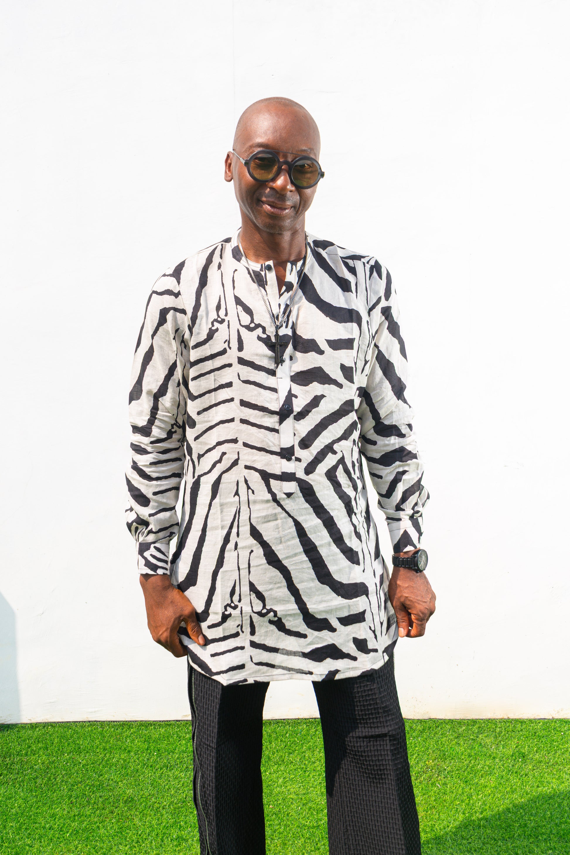 Patterned Shirt featuring a long-sleeve white tunic with bold black zebra-inspired patterns, a buttoned neckline, and a straight hem.