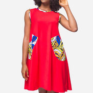 Shift Dress featuring a sleeveless, flowing red jersey mini dress accented with colorful geometric African print accents at the shoulders and large curved side patch pockets