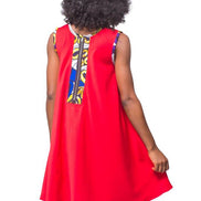 Shift Dress featuring a sleeveless, flowing red jersey mini dress accented with colorful geometric African print accents at the shoulders and large curved side patch pockets