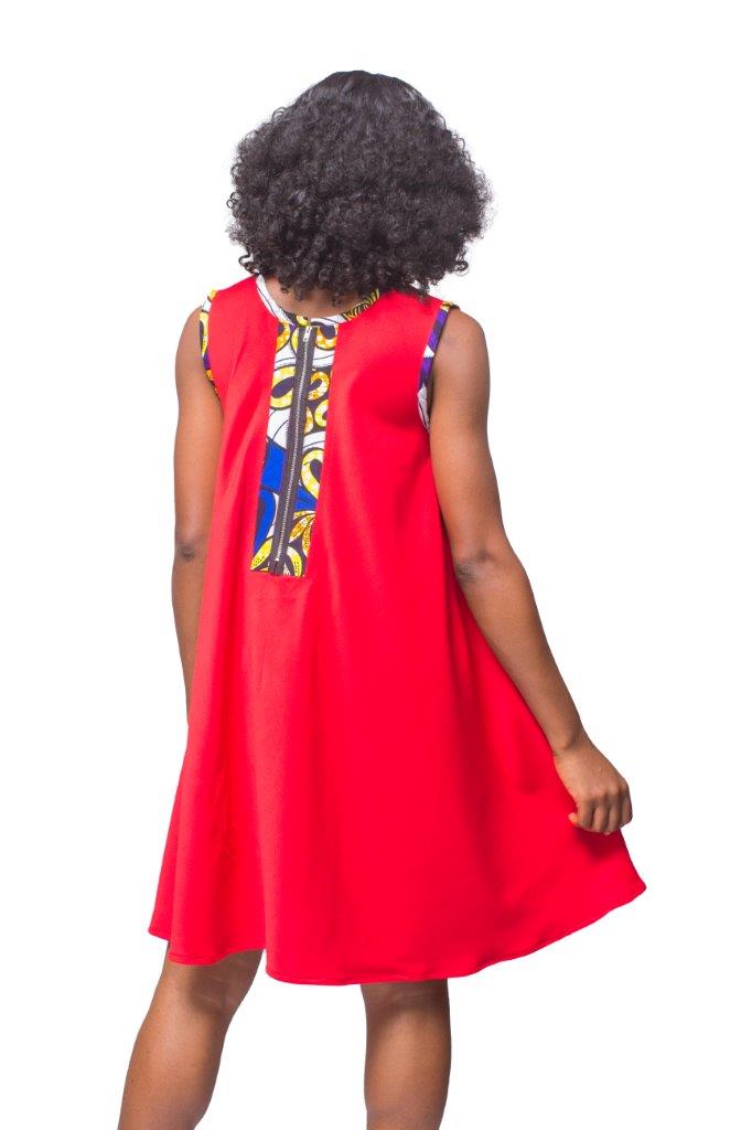 Shift Dress featuring a sleeveless, flowing red jersey mini dress accented with colorful geometric African print accents at the shoulders and large curved side patch pockets