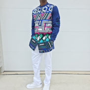Shirt featuring an abstract geometric front panel in bright pink, teal, blue, and black-and-white lines, finished with navy blue sleeves that display three horizontal pleated cutouts.