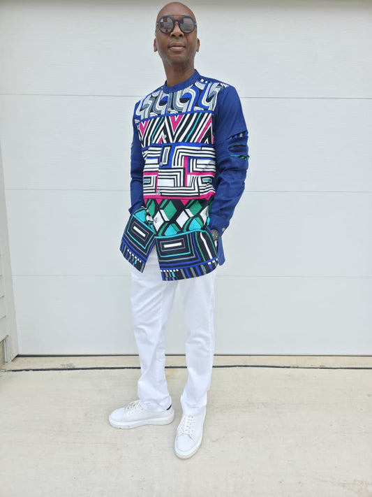 Shirt featuring an abstract geometric front panel in bright pink, teal, blue, and black-and-white lines, finished with navy blue sleeves that display three horizontal pleated cutouts.