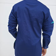 Shirt featuring an abstract geometric front panel in bright pink, teal, blue, and black-and-white lines, finished with navy blue sleeves that display three horizontal pleated cutouts.