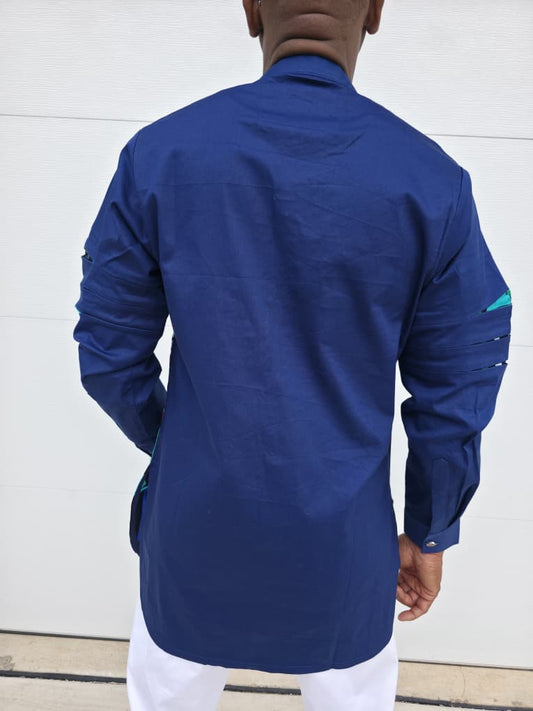 Shirt featuring an abstract geometric front panel in bright pink, teal, blue, and black-and-white lines, finished with navy blue sleeves that display three horizontal pleated cutouts.