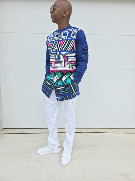 Shirt featuring an abstract geometric front panel in bright pink, teal, blue, and black-and-white lines, finished with navy blue sleeves that display three horizontal pleated cutouts.