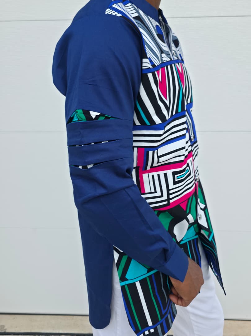 Shirt featuring an abstract geometric front panel in bright pink, teal, blue, and black-and-white lines, finished with navy blue sleeves that display three horizontal pleated cutouts.