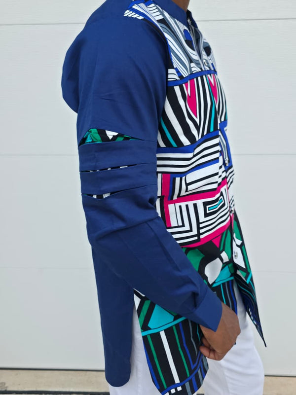 Shirt featuring an abstract geometric front panel in bright pink, teal, blue, and black-and-white lines, finished with navy blue sleeves that display three horizontal pleated cutouts.