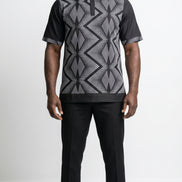 Shirt featuring a short-sleeved silhouette with a black and white optical diamond Ankara print on the chest, contrasted by solid black sleeves, collar, and side panels.