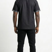 Shirt featuring a short-sleeved silhouette with a black and white optical diamond Ankara print on the chest, contrasted by solid black sleeves, collar, and side panels.