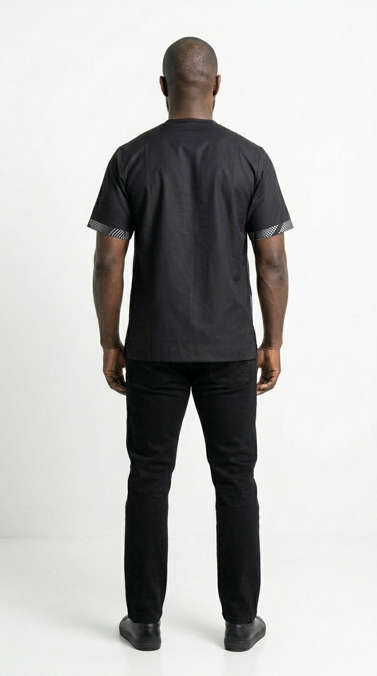 Shirt featuring a short-sleeved silhouette with a black and white optical diamond Ankara print on the chest, contrasted by solid black sleeves, collar, and side panels.