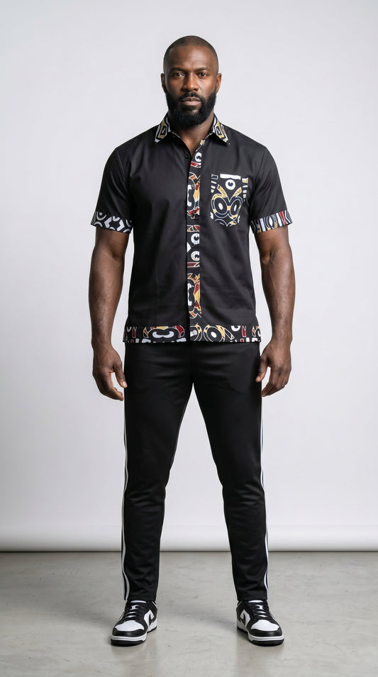 Shirt featuring a short-sleeved black button-down silhouette with vibrant graphic Ankara prints on the collar, pocket, central placket, and hem.