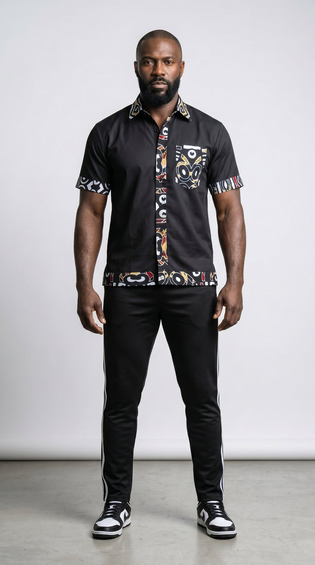 Shirt featuring a short-sleeved black button-down silhouette with vibrant graphic Ankara prints on the collar, pocket, central placket, and hem.