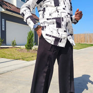 Shirt featuring a black and white geometric abstract print, a structured high half collar, and elongated double cuffs.