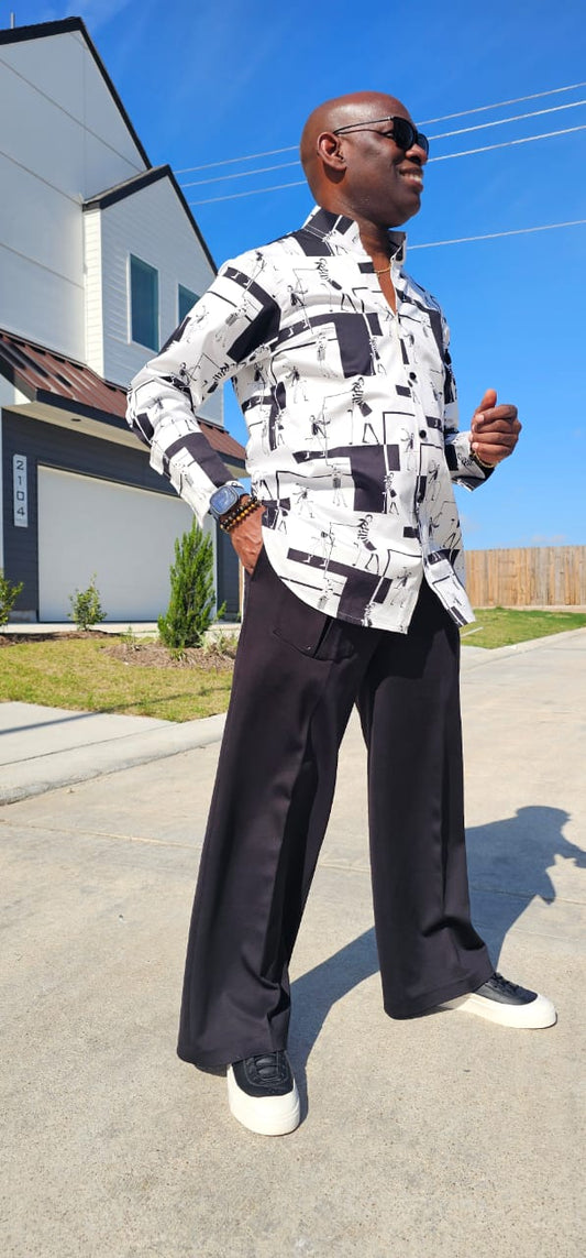 Shirt featuring a black and white geometric abstract print, a structured high half collar, and elongated double cuffs.