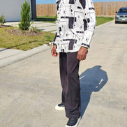 Shirt featuring a black and white geometric abstract print, a structured high half collar, and elongated double cuffs.